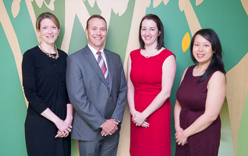 Pediatric Faculty Photo of Drs. Riedesel, Maxfield, Gill, and Nguyen standing against a leafy mural in the American Family Children's Hospital Imaging Pavilion