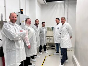Members of the Departments of Radiology from UW-Madison and Erasmus MC wear protective clothing and boots as they tour the Erasmus MC cyclotron, including Rianne van der Heijden, MD, PhD (second from left); Jason Mixdorf, PhD (third from left); Jonathan Engle, PhD (fourth from left); Erik Verburg, MD, PhD (first from right).