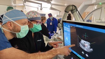 John Swietlik, MD, and Erica Knavel Koepsel, MD monitoring the ’bubble cloud’ created around cancerous cells during the procedure.