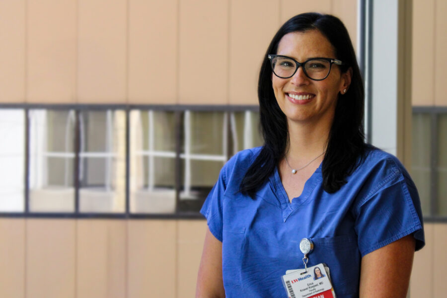 Profile image of Erica Knavel standing in front of a wall