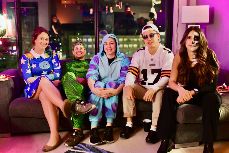 Group of fellows in different Halloween costumes sitting down