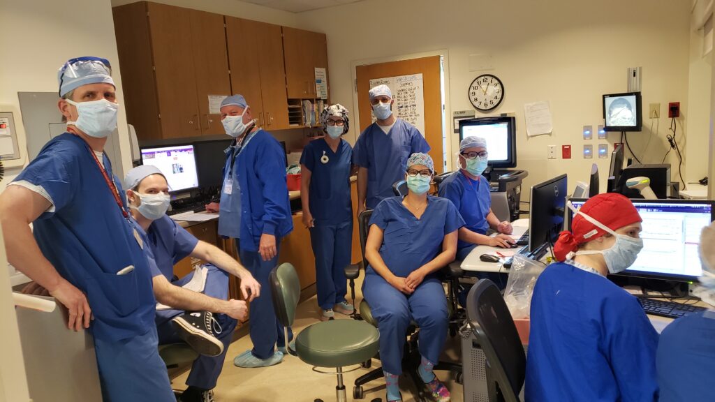 Group of medical faculty members standing and sitting in their office