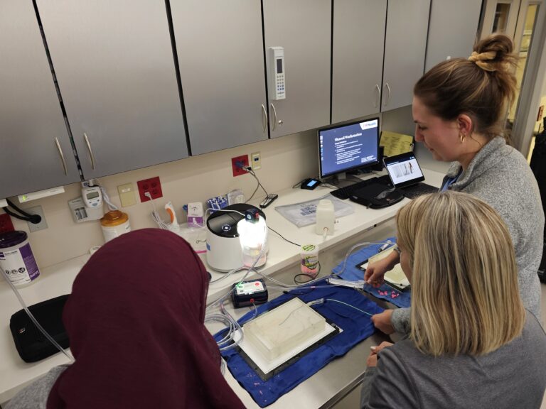 Students watch an interventional radiology demonstration.