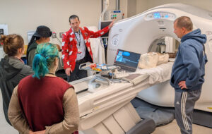 Tim Szczykutowicz, PhD talks to students visiting to the Wind River Reservation during a demonstration scanning fossils from their sovereign land.