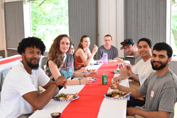 Group of 8 residents sitting at the table with food
