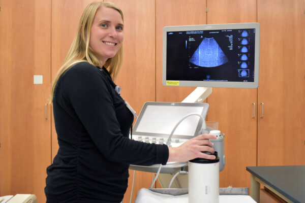 Kelsey Small, Ultrasonagrapher Lead, with the scanner (photo credit: Catherine Showers)