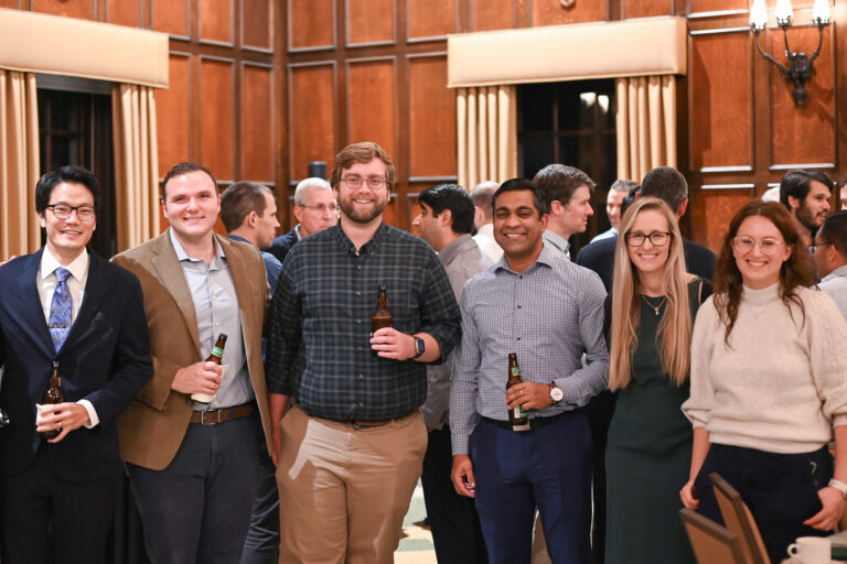 Faculty members smiling