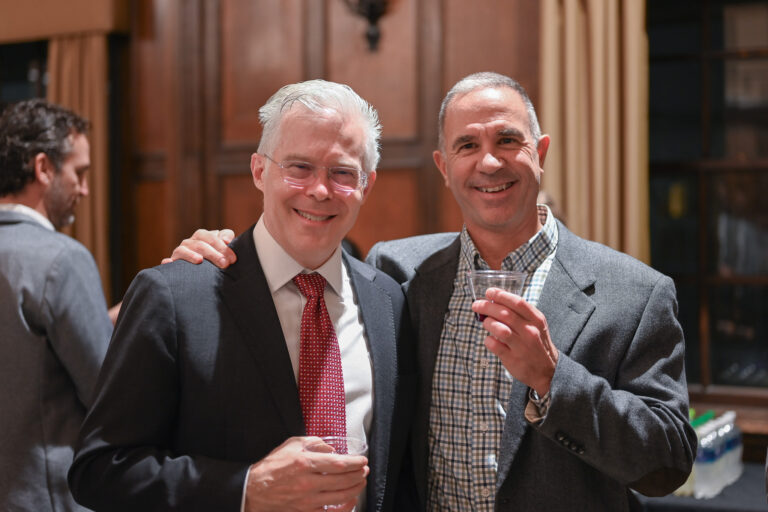 Scott Reeder taking a photo with a faculty member