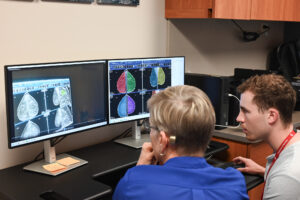Lonie Salkowski and research intern Logan Murphy review the eye-tracking footage and data points from one of the resident case reviews.