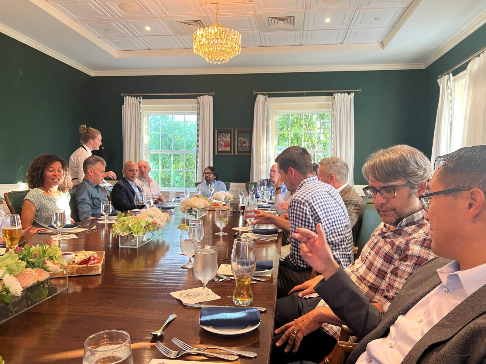 A group of people eat dinner at a table. 