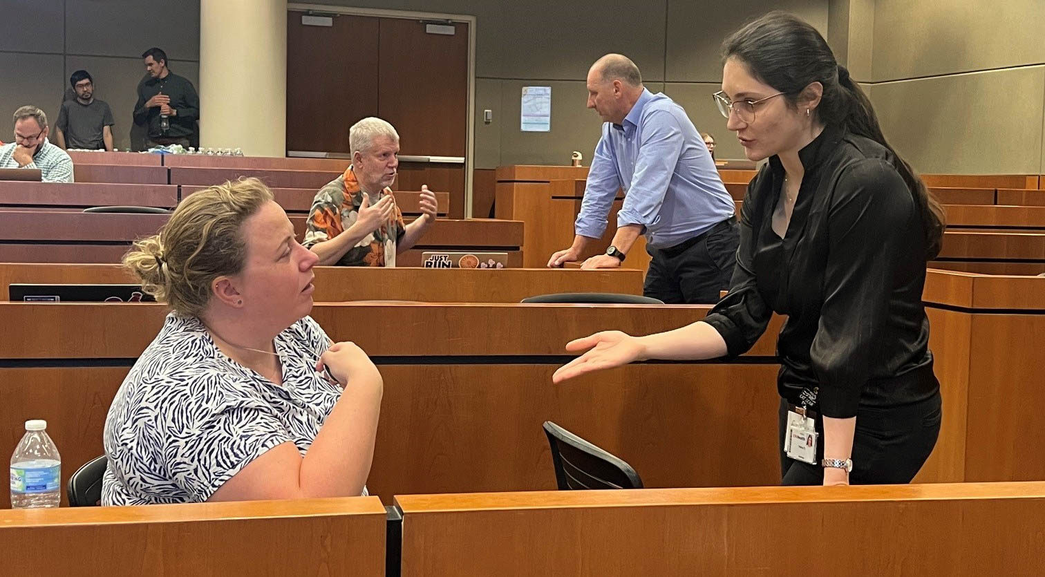 Faculty talk to each other during a symposium. 