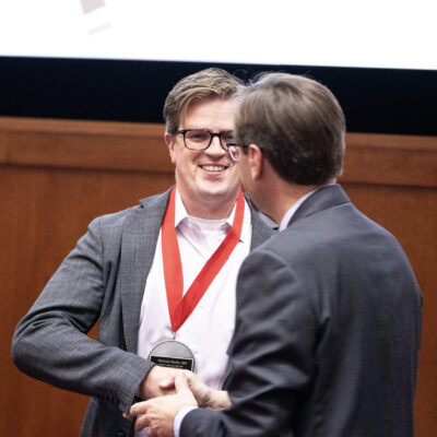 Nicholas Burris, MD shakes Art Walaszek, MD’s hand after being presented with his medallion. Photo courtesy of UW Health and John Maniaci.