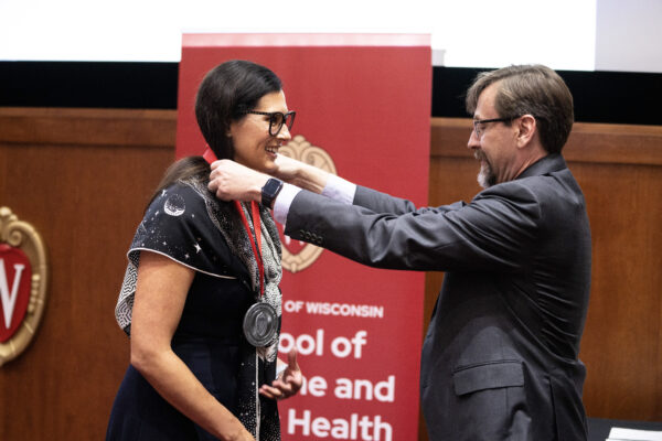 Erica Knavel Koepsel, MD receives her medallion from Art Walaszek, MD at the 2025 School of Medicine and Public Health Faculty Investiture Celebration. Photo courtesy of UW Health and John Maniaci.