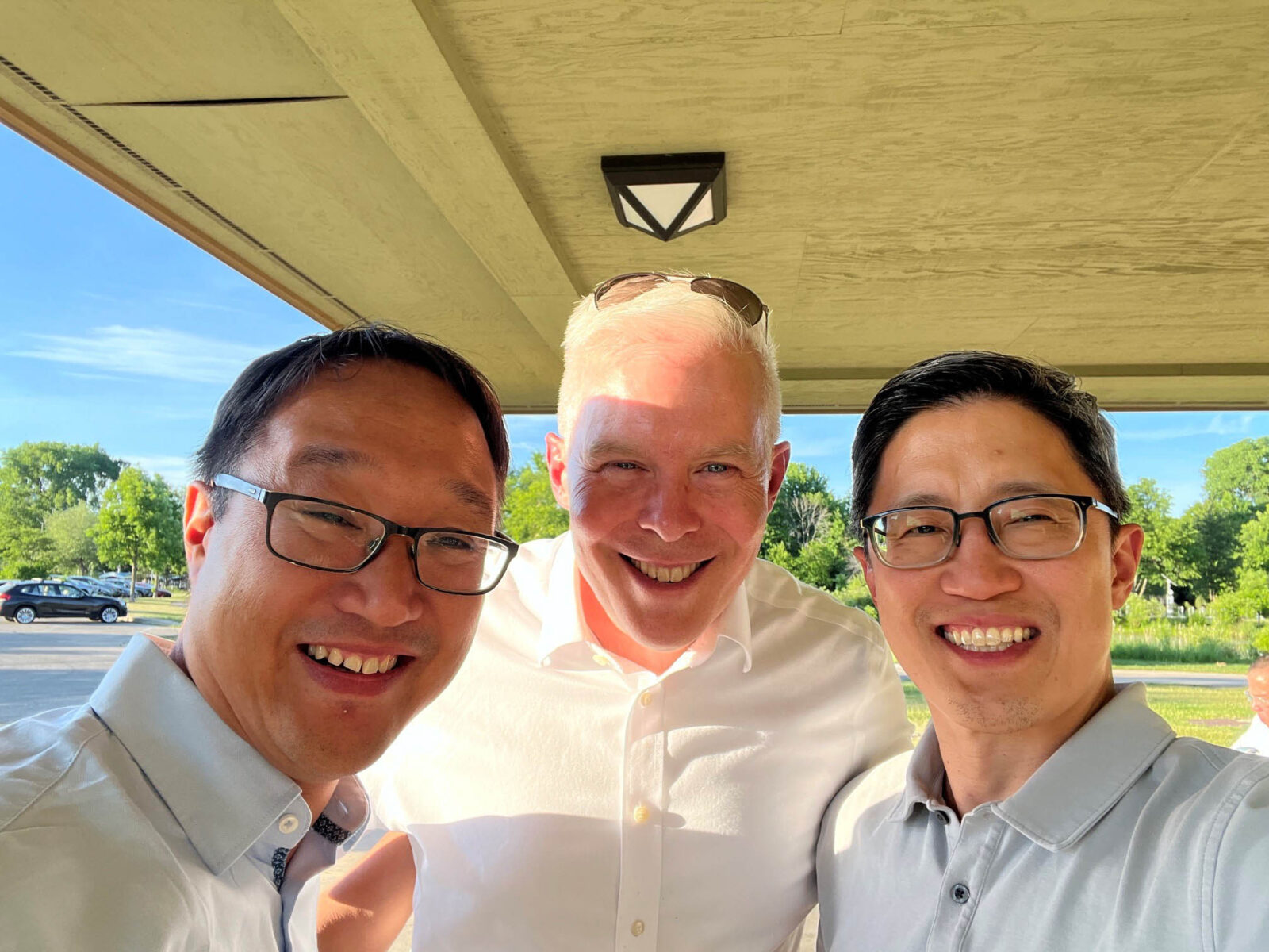 Three people smile for a photo. 