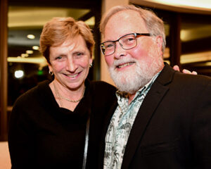 Howard Rowley taking a photo with another person