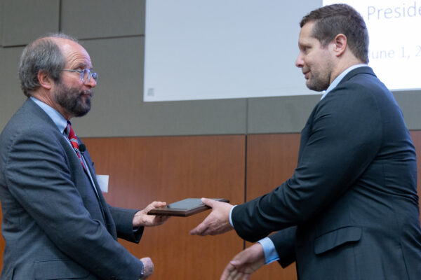 Dr. Avey accepts his award from Dean Golden at Medical Education Day in the Health Sciences Learning Center. (Photo courtesy of Media Solutions)