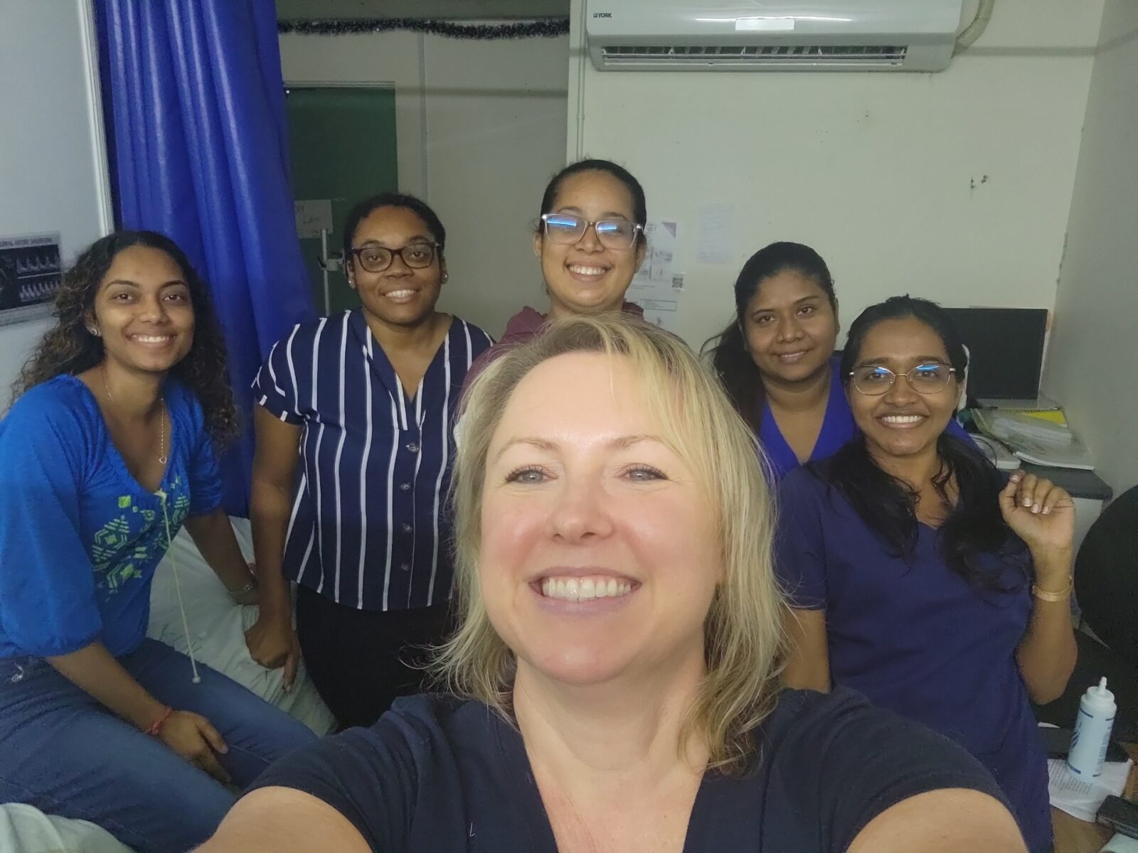 Ultrasongrapher Christina Hendricks takes a selfie with residents in Guyana.